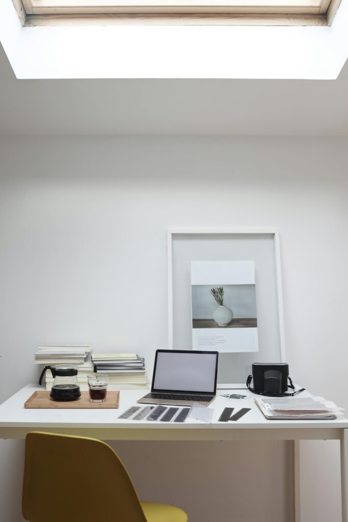 Clean workspace with laptop, coffee, and French press representing productivity and online affiliate marketing lifestyle