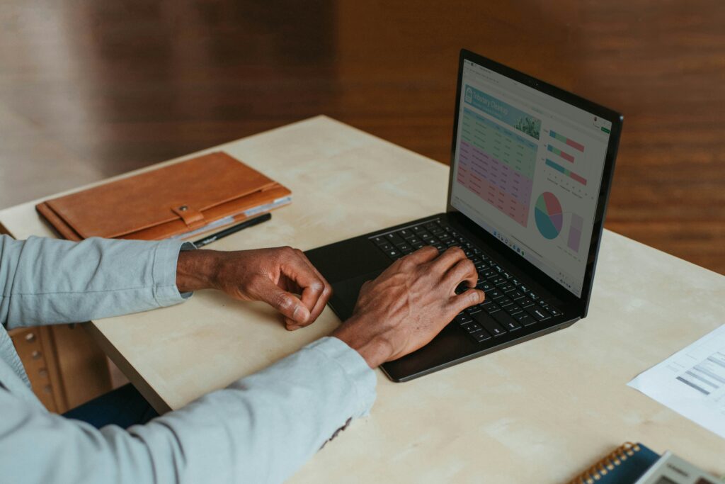 Person working on a laptop showing a digital marketing dashboard with charts and analytics on the screen.